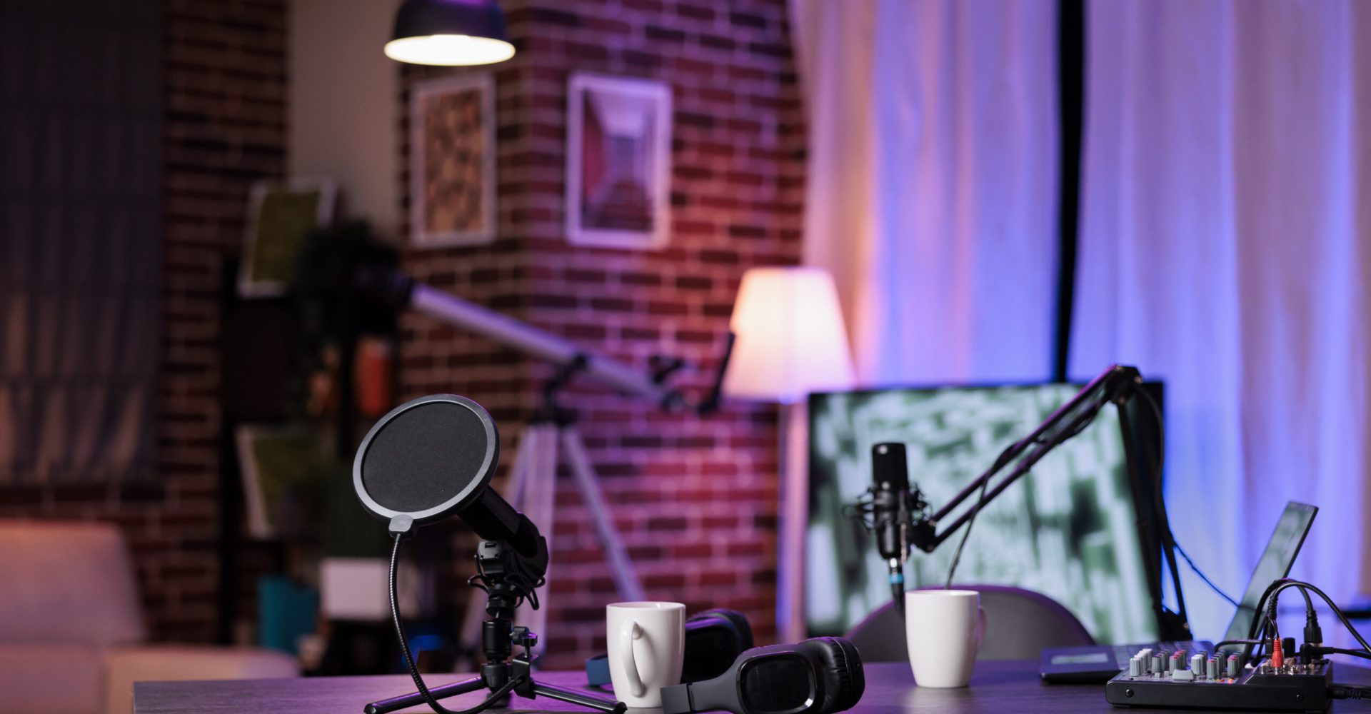 Nobody at empty desk with streaming equipment to broadcast live conversation on social media. No people in space with podcast station, microphone and headphones, sound production.